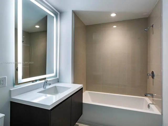 a bathroom with a bathtub and a sink