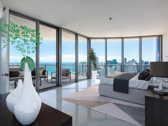 a living room with furniture and a floor to ceiling window