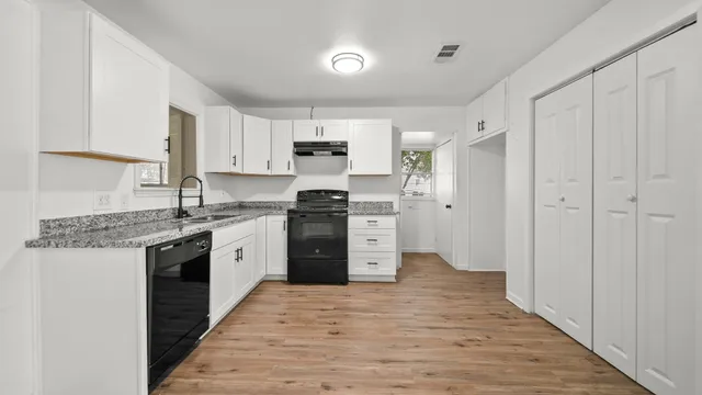a kitchen with stainless steel appliances granite countertop a stove and a refrigerator