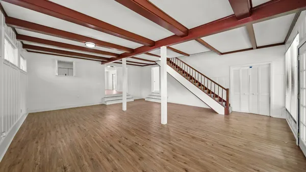 a view of an entryway with wooden floor