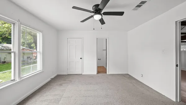 a view of room with a ceiling fan