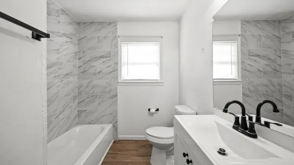 a bathroom with a sink toilet and bathtub