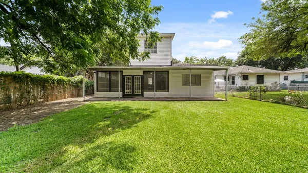 a front view of house with yard and green space