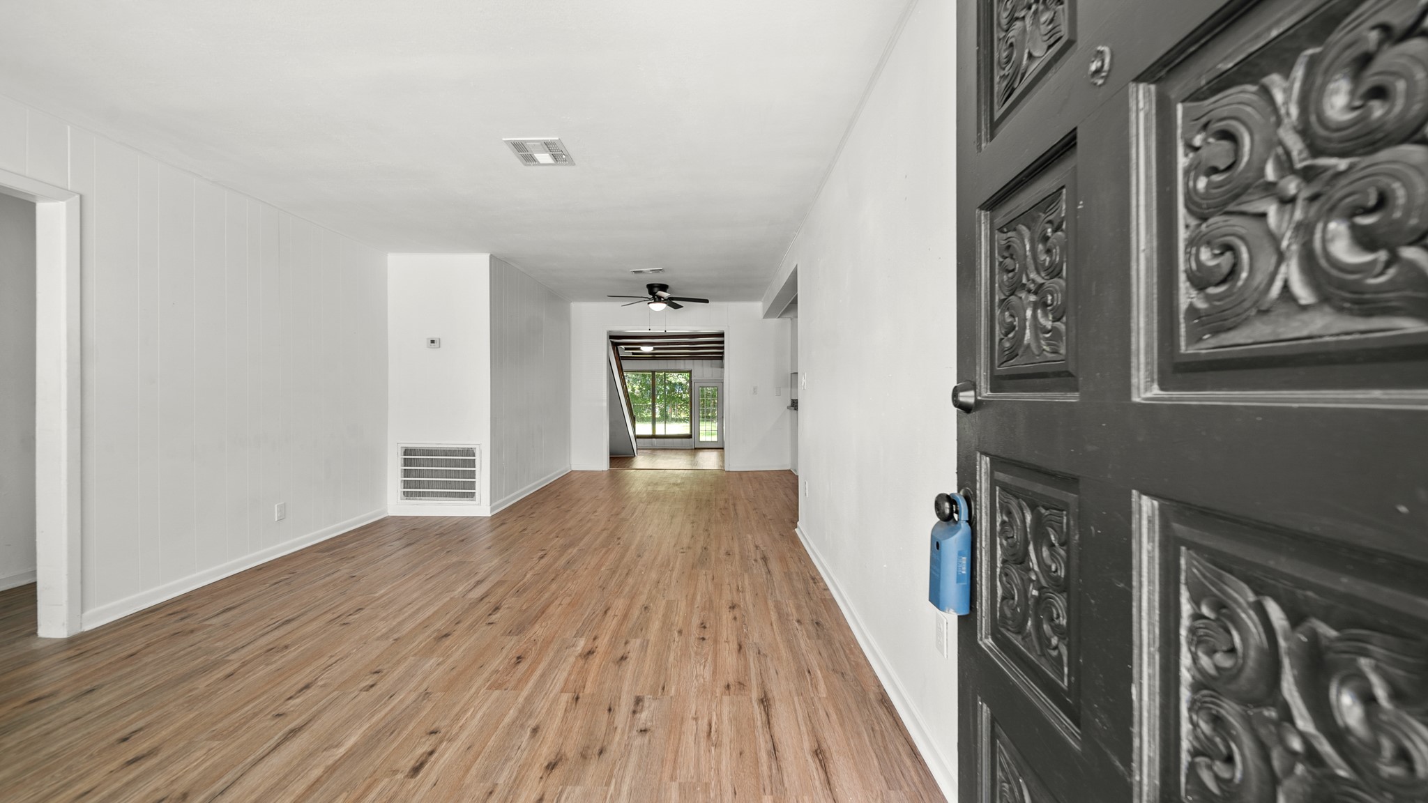 8327 Bonner Drive Houston, TX 77017 - Photo 8 of 37 a view of a hallway with wooden floor and a bathroom