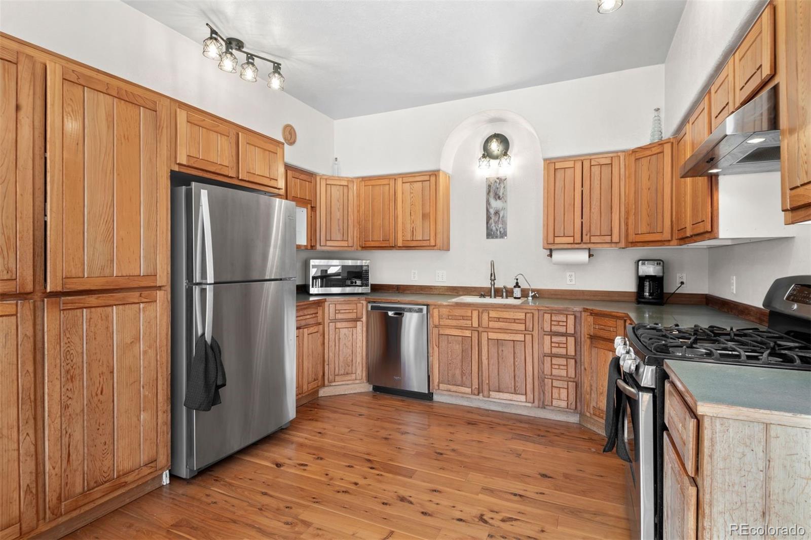 1740 County Road 72 Bailey, CO 80421 - Photo 12 of 40 a kitchen with granite countertop a refrigerator stove top oven and sink