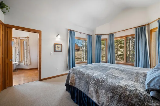 a bedroom with a bed next to a window