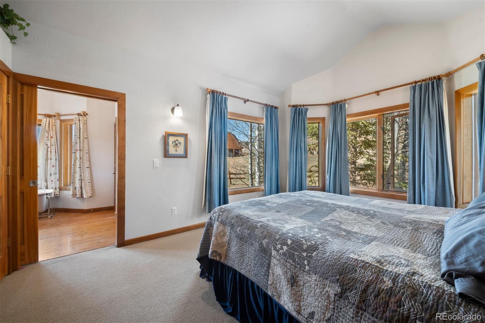 1740 County Road 72 Bailey, CO 80421 - Photo 15 of 40 a bedroom with a bed next to a window