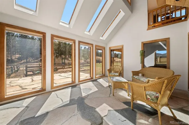 a living room with furniture and large windows