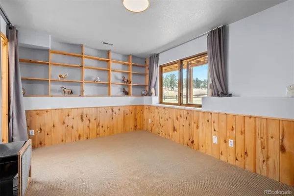 a large white kitchen with a large window