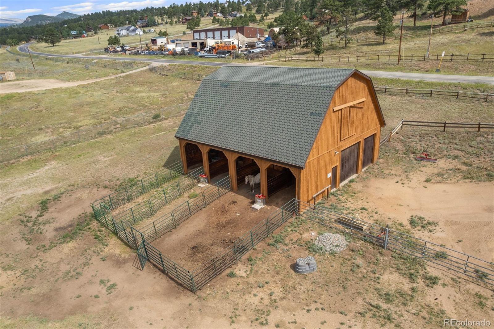 1740 County Road 72 Bailey, CO 80421 - Photo 27 of 40 a view of swimming pool with outdoor seating and lake view