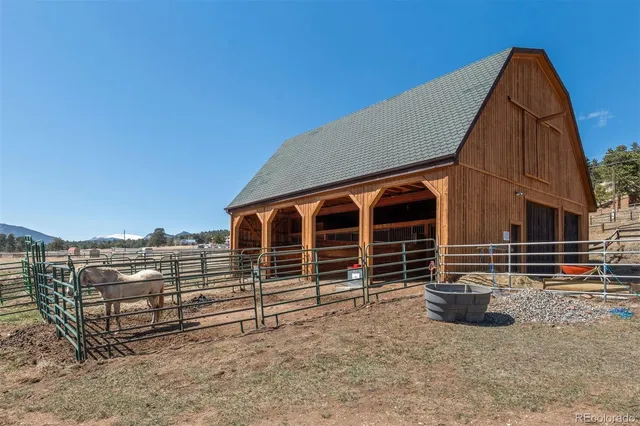 a view of a chair and table in the backyard