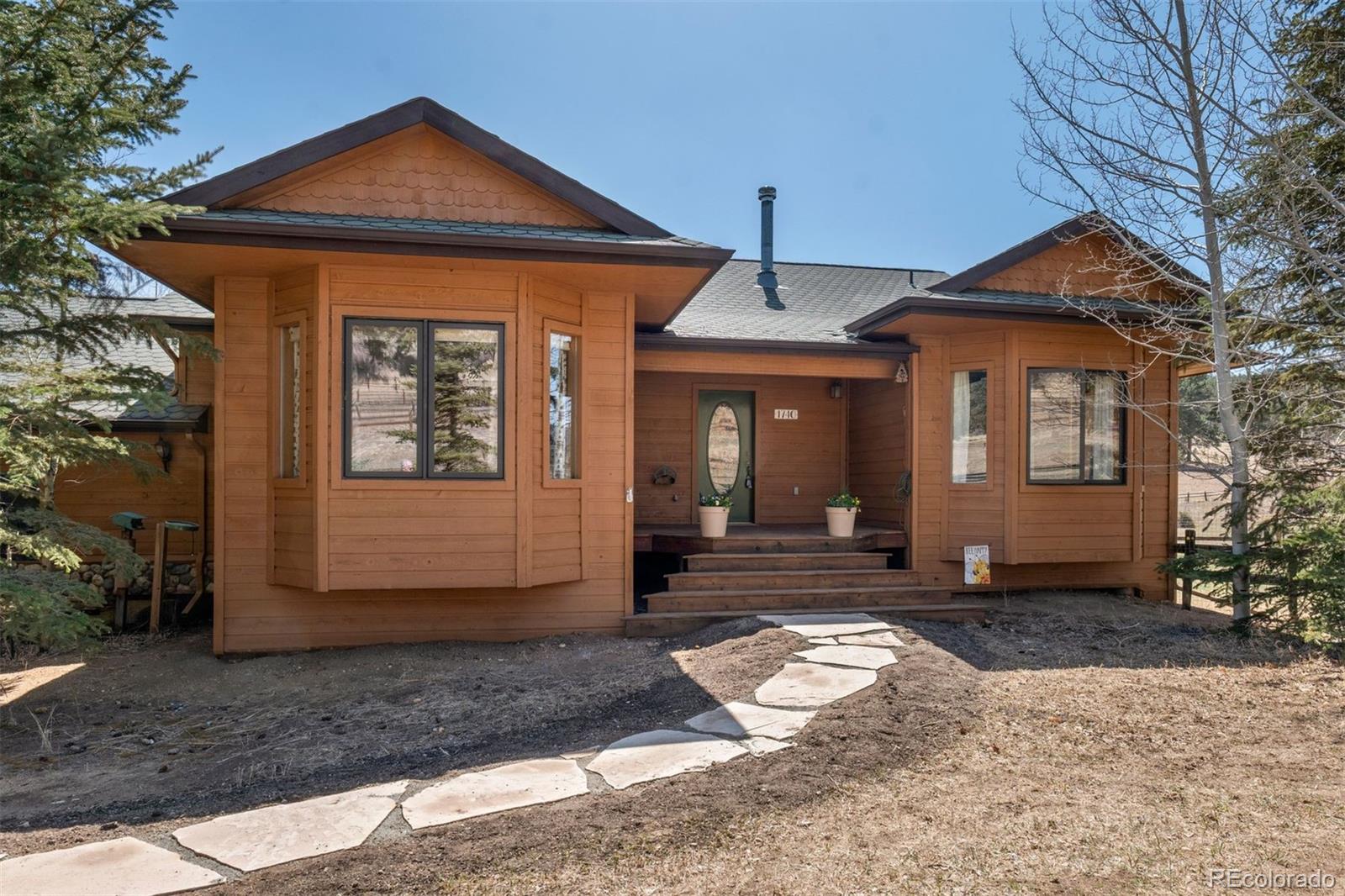 1740 County Road 72 Bailey, CO 80421 - Photo 5 of 40 a front view of a house with a yard