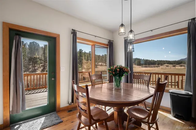 a dining room with furniture window and outside view