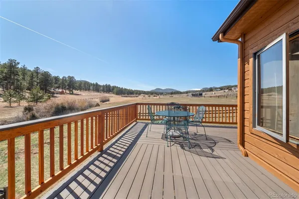 a view of balcony with wooden floor and fence