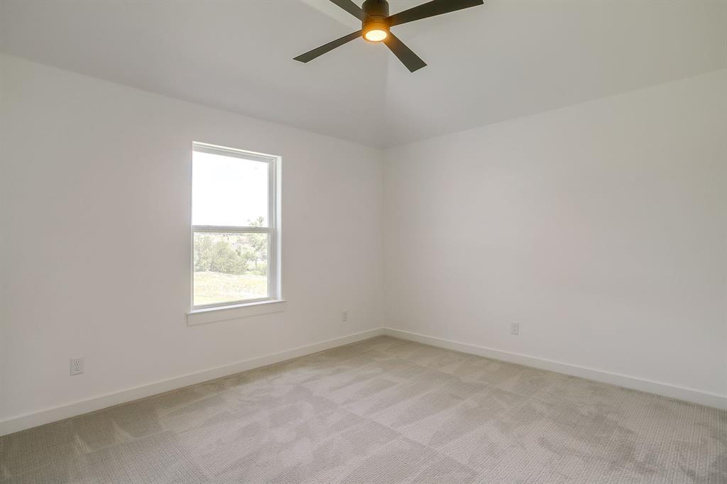 9012 Valley Oak Court Springtown, TX 76082 - Photo 24 of 40 an empty room with a window and a fan