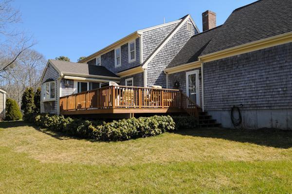 141 Elliott Road Centerville, MA 02632 - Photo 3 of 17 a front view of a house with a yard