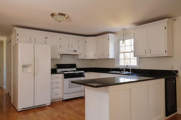 141 Elliott Road Centerville, MA 02632 - Photo 9 of 17 a kitchen with granite countertop white cabinets and white appliances