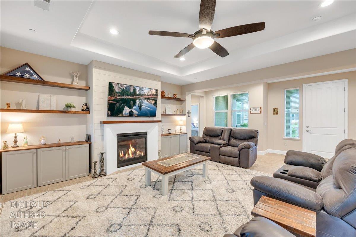133 Palisades Place Copperopolis, CA 95228 - Photo 12 of 89 a living room with furniture a fireplace and a flat screen tv
