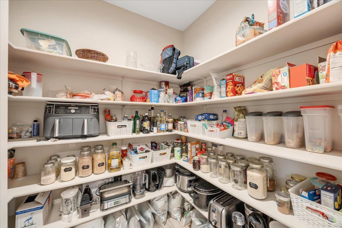133 Palisades Place Copperopolis, CA 95228 - Photo 23 of 89 a cabinet in a kitchen with stainless steel appliances toys and wooden floor