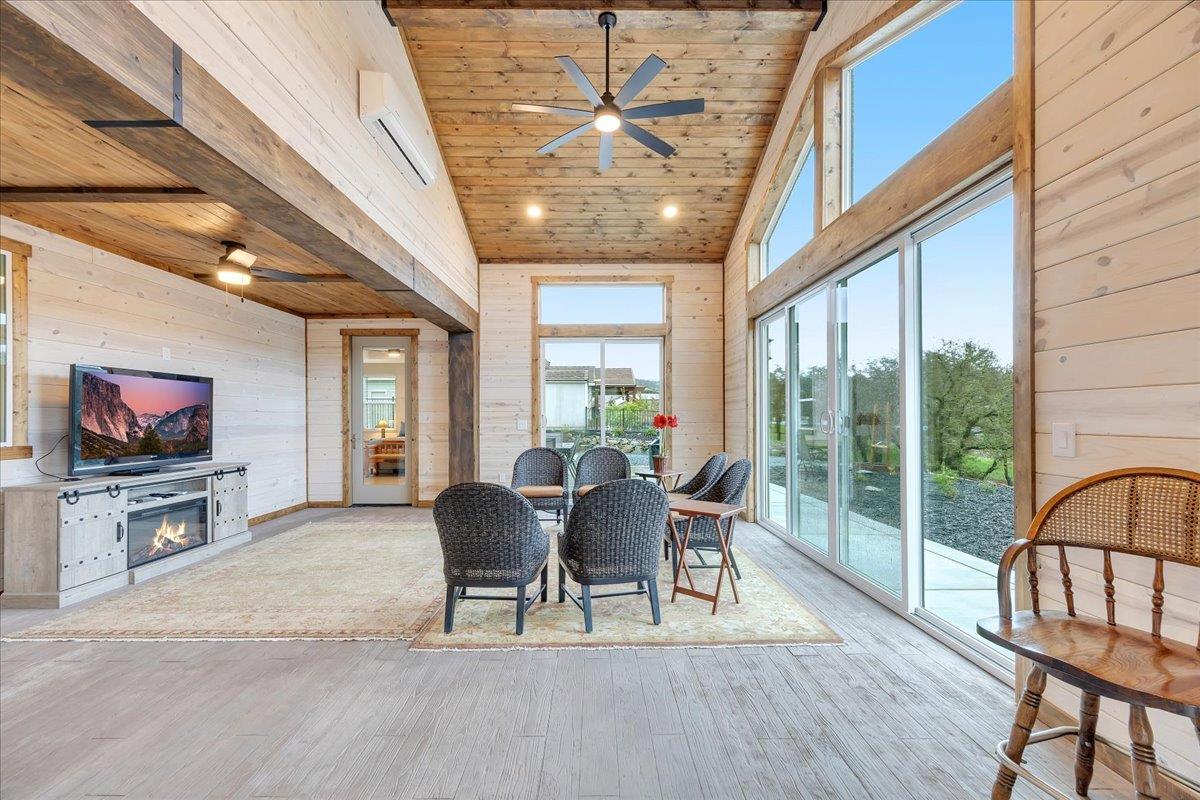 133 Palisades Place Copperopolis, CA 95228 - Photo 27 of 89 Vaulted ceiling, knotty pine, rustic beams, wood-look concrete floor and windows galore! Separate mini-split for heating and cooling keeps this space comfortable and the perfect addition to the living space.