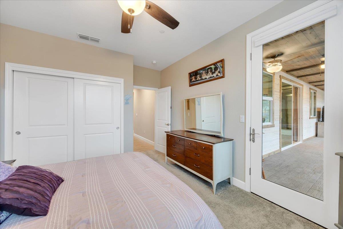 133 Palisades Place Copperopolis, CA 95228 - Photo 67 of 89 a bedroom with a bed and a chandelier