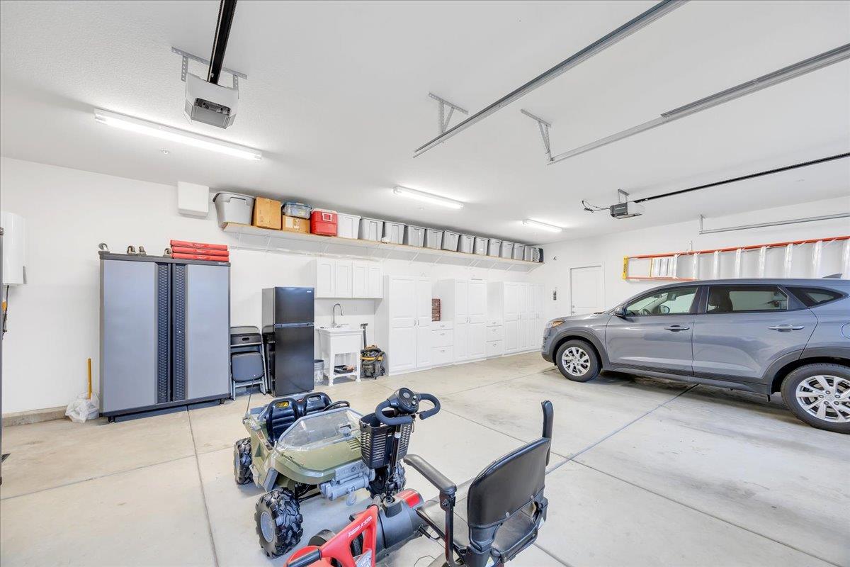 133 Palisades Place Copperopolis, CA 95228 - Photo 69 of 89 Spacious 3-car garage with storage shelf, cabinets, and sink.
