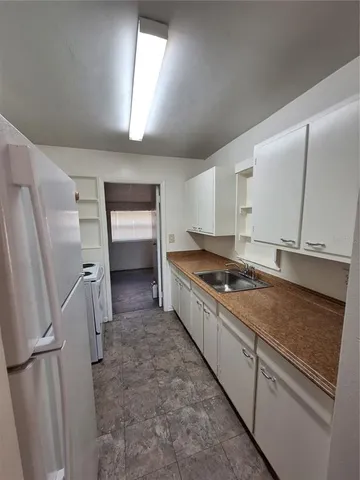 a kitchen with stainless steel appliances a refrigerator sink and stove