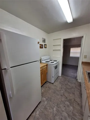 a kitchen with stainless steel appliances a refrigerator a stove a microwave and a refrigerator