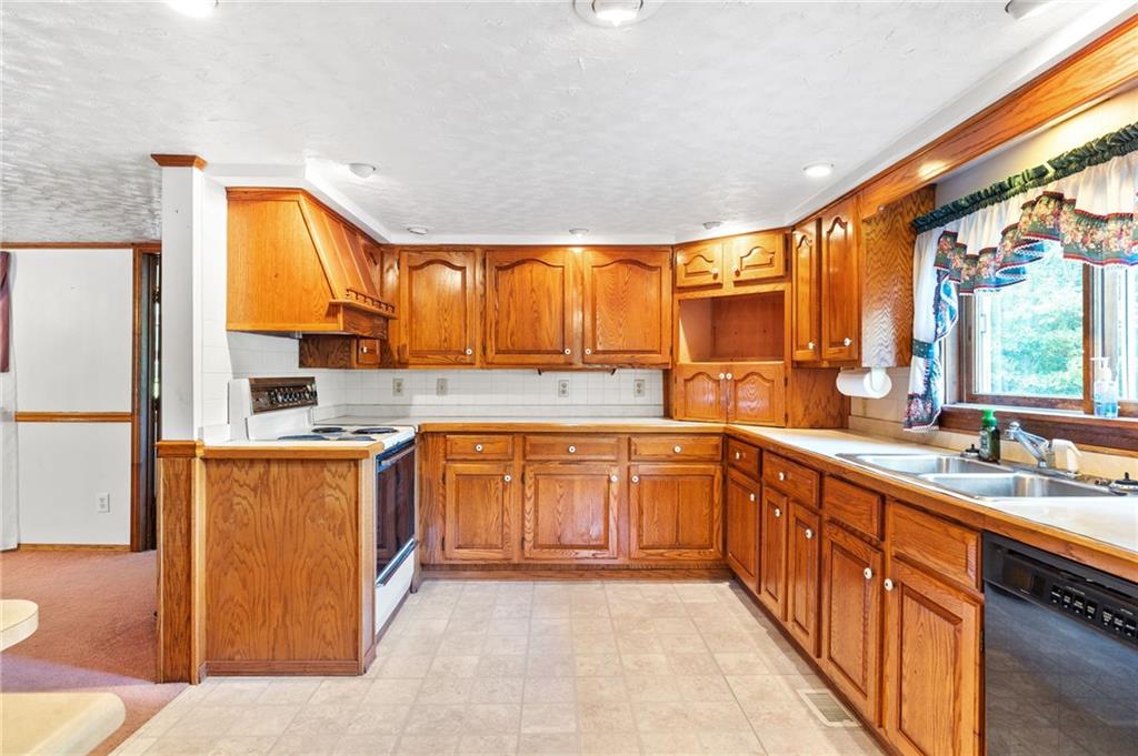 194 Conner School Road Wampum, PA 16157 - Photo 2 of 25 a large kitchen with stainless steel appliances granite countertop a sink and cabinets