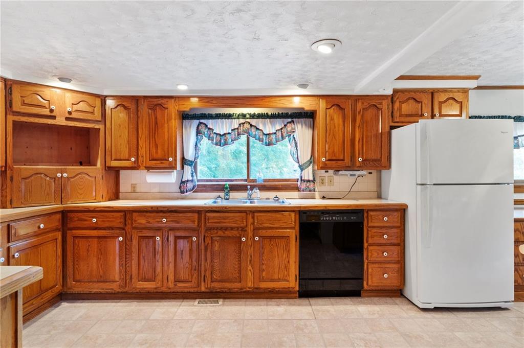 194 Conner School Road Wampum, PA 16157 - Photo 11 of 25 a kitchen with stainless steel appliances granite countertop a refrigerator and a sink