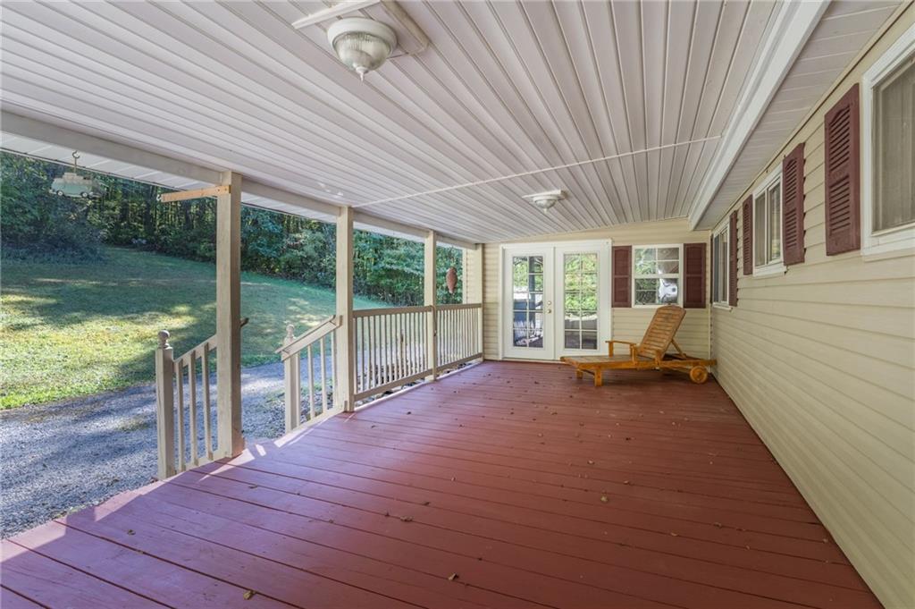 194 Conner School Road Wampum, PA 16157 - Photo 8 of 25 a house with wooden floor outdoor seating and yard