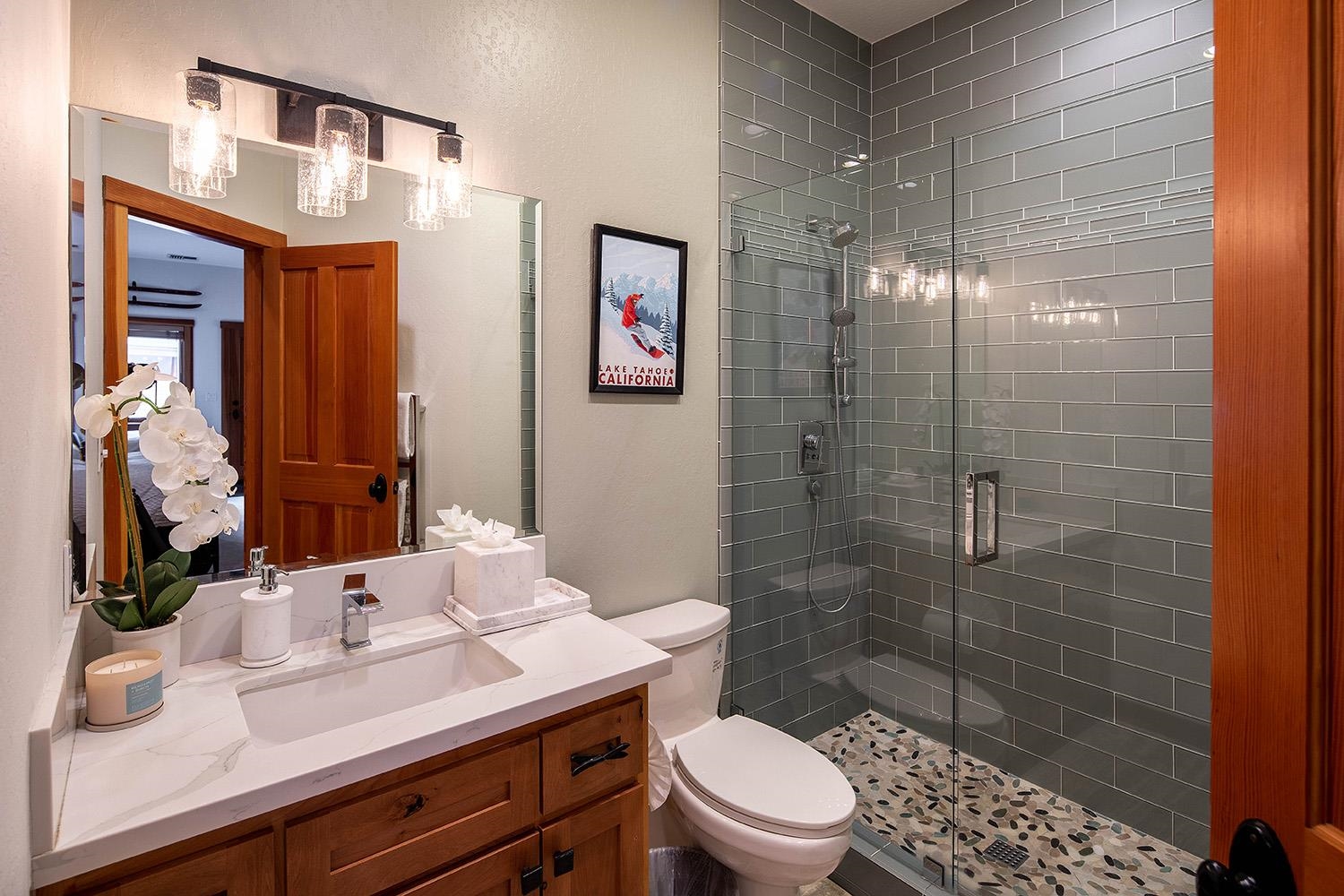135 Alpine Meadows Road, Unit 33 Alpine Meadows, CA 96145 - Photo 17 of 21 a bathroom with a sink a toilet a mirror and shower