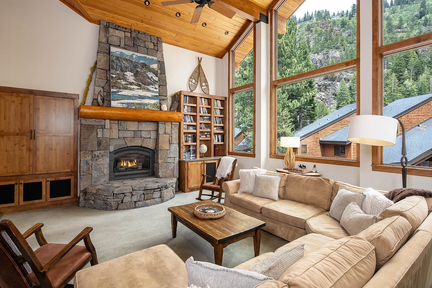 135 Alpine Meadows Road, Unit 33 Alpine Meadows, CA 96145 - Photo 3 of 21 a living room with furniture a fireplace and a large window