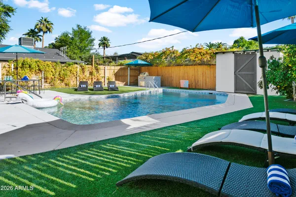 a view of a backyard with sitting area