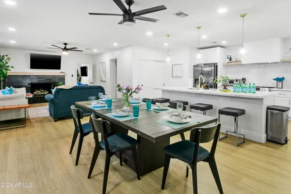 a kitchen with a dining table and chairs
