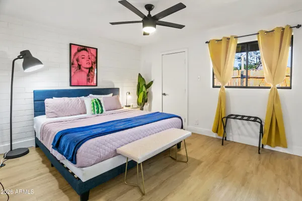 a bedroom with a bed and wooden floor