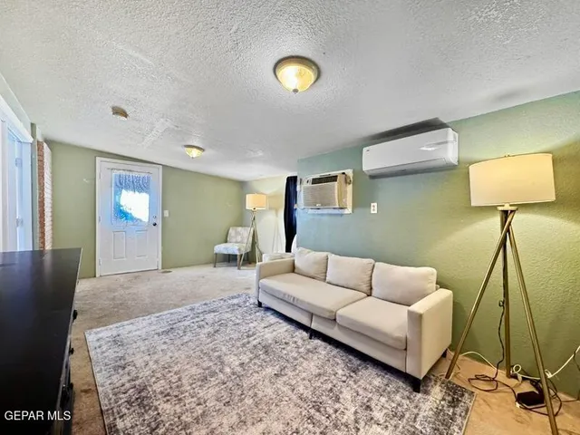 a living room with furniture and a lamp