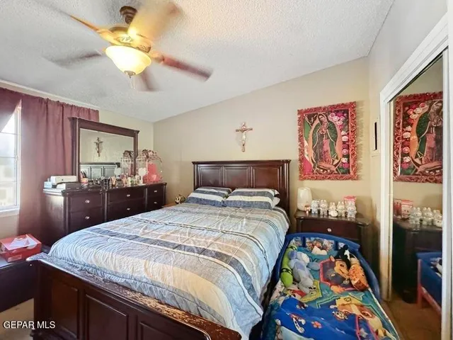a bedroom with a bed and a painting on the wall