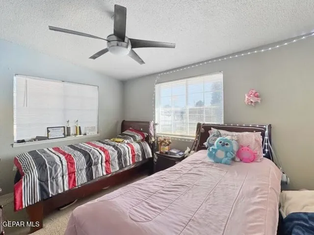 a bedroom with two beds and a window