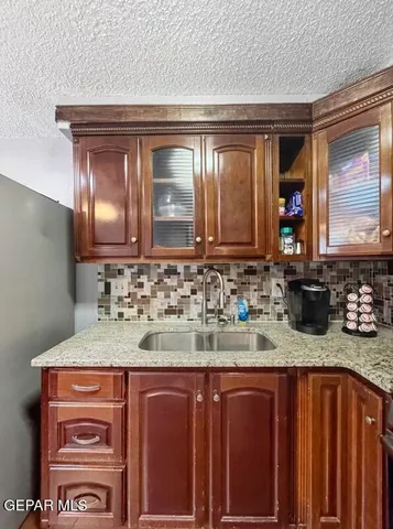 a bathroom with a granite countertop sink a vanity and a mirror
