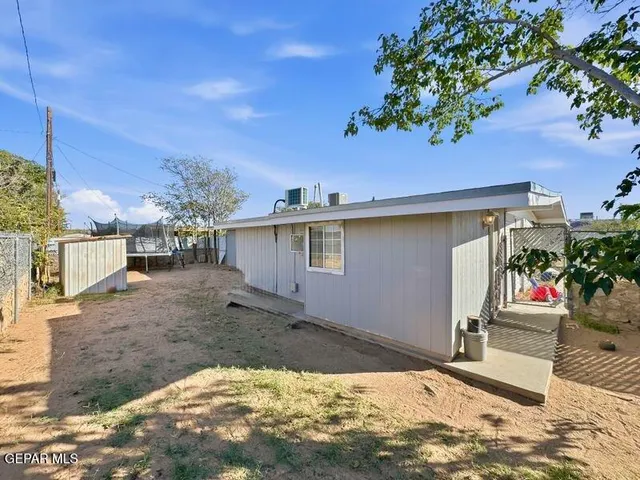 a view of a house with a tree in front of it