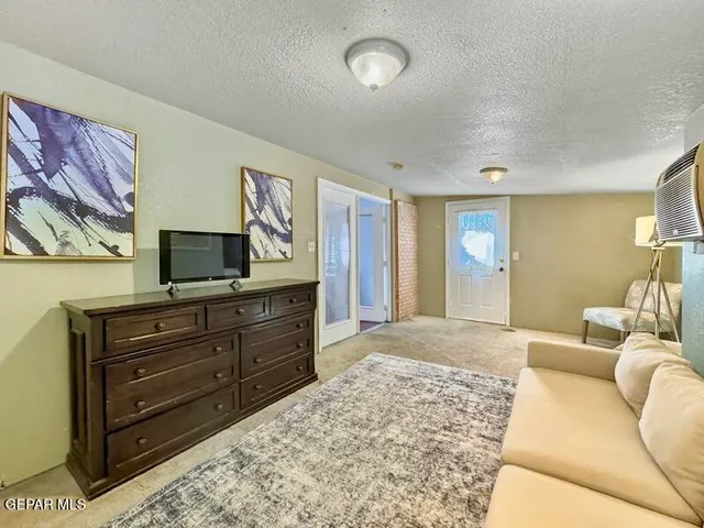 a living room with couches and flat screen tv