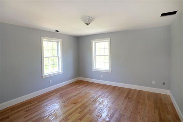115 B Lakeshore Road Boxford, MA 01921 - Photo 13 of 21 an empty room with wooden floor and windows