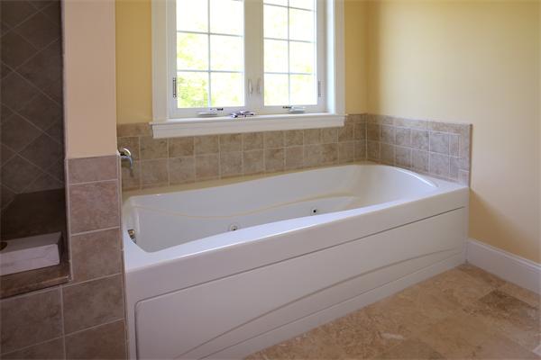115 B Lakeshore Road Boxford, MA 01921 - Photo 16 of 21 a bathroom with a bathtub and window