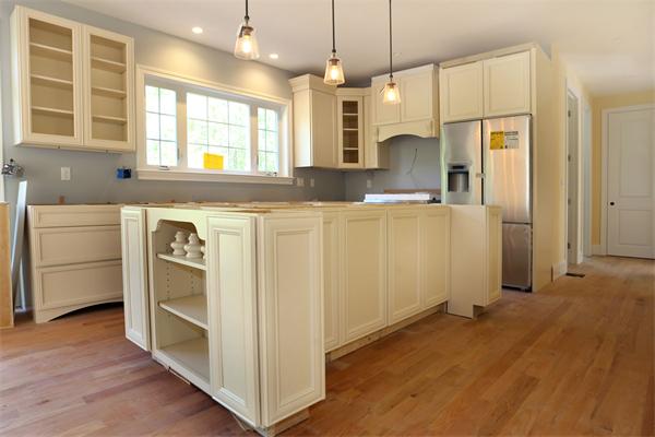115 B Lakeshore Road Boxford, MA 01921 - Photo 3 of 21 a kitchen with stainless steel appliances granite countertop a refrigerator a sink dishwasher a oven and a dining table with wooden floor