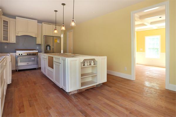 115 B Lakeshore Road Boxford, MA 01921 - Photo 4 of 21 a kitchen with a stove and a wooden floor