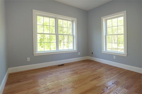 115 B Lakeshore Road Boxford, MA 01921 - Photo 7 of 21 a view of an empty room with wooden floor and a window