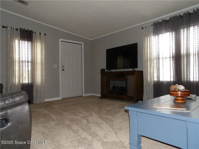 a living room with a flat screen tv and a fireplace
