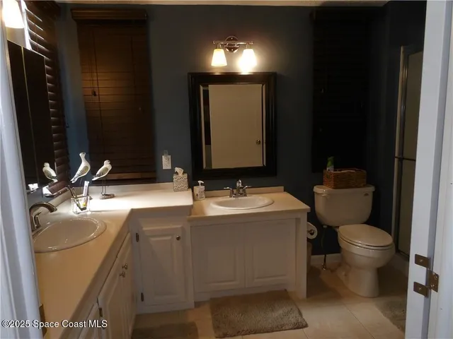 a bathroom with a sink toilet and mirror