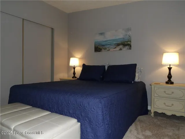 a bedroom with a bed and a lamp